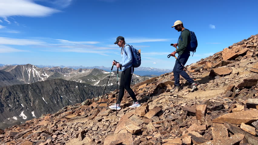Quandary Peak trail fourteener two hikers hike mountaineer down the Rocky Mountain summer blue sky cloudy Colorado adventure top peak Breckenridge Summit CountyContinental Divide Kenosha pass pan left