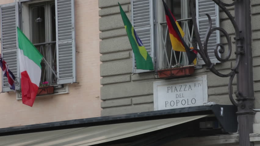 Sign titled Piazza Del Popolo above an awning