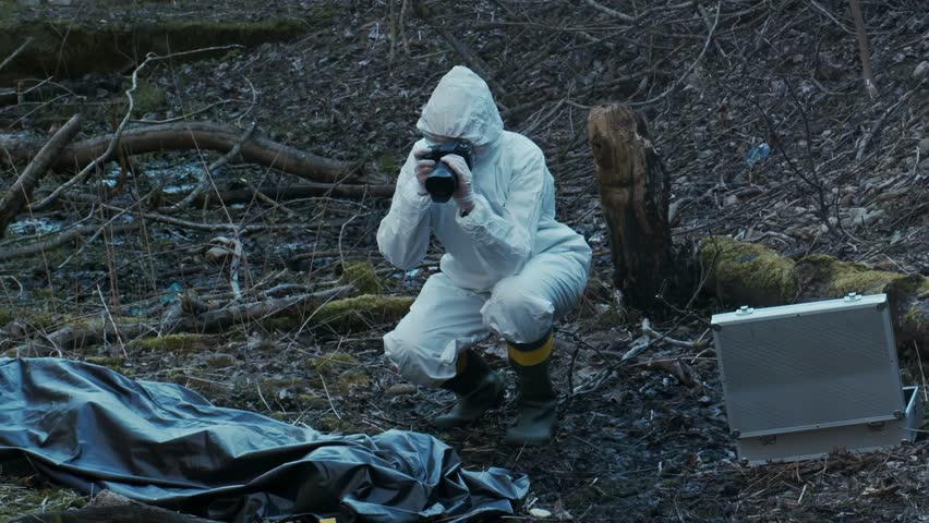 Forensic specialist working in the forest. Police criminalists collecting evidence and making criminal investigation. Crime scene concept. Royalty-Free Stock Footage #3457779261