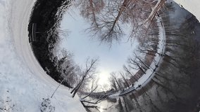 Embark on a captivating journey through a serene winter forest in this 360-degree virtual reality video. The soft crunch of snow underfoot and the gentle murmur of a nearby river create a peaceful
