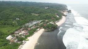 4k Video Footage - Aerial view of Sundak beach in Gunungkidul, Yogyakarta, Indonesia with crashing waves during the day.