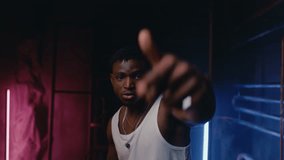 Young muscular rapper dancing in neon lights of cool nightclub - Powered by Shutterstock - Get 15% off with code: PIKWIZARD15