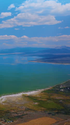 Mesmerizing turquoise scenery of lake joining with sky. Amazing saline soda Mono Lake in California from aerial perspective. Vertical video.