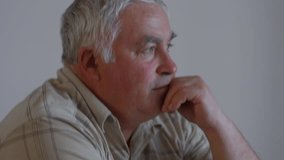 Portrait of Sadness side view headshot capturing the deep emotions etched on the face of a bearded senior, expressing the complexities of a lonely and depressed life at home. - Powered by Shutterstock - Get 15% off with code: PIKWIZARD15