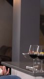 Two young people with a glass of wine in a romantic evening in the kitchen of their home, lifestyle of a couple on Valentine's Day. 4k video