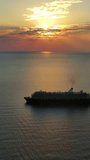 Aerial view at the cruise ship during sunset. Landscape with cruise liner on Adriatic sea. Adventure and travel. Vertical video