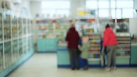 A dynamic cinematic video showcasing a bustling pharmacy with customers browsing shelves and waiting in line. Ideal for showcasing consumerism and the healthcare industry