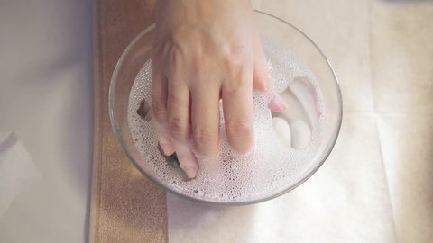 procedure moisturizing nail, hand lay in the bath with water. Close-up. Manicure beauty salon. manicurist makes the procedure for the care of nails