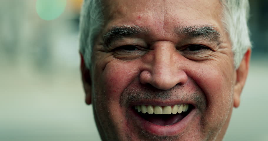 Portrait of a joyful senior casual man smiling at camera tight close-up face with authentic grin, 70s older person