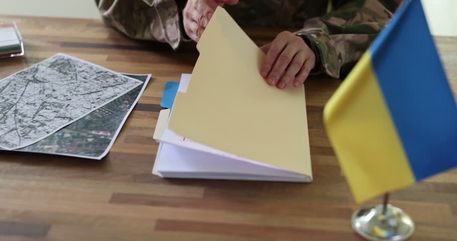 Military reading top secret document on planning of counteroffensive of ukrainian troops closeup 4k movie slow motion. Defense strategies of ukrainian territory during war with russia concept Royalty-Free Stock Footage #3458086257