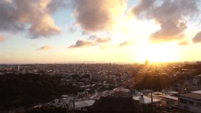 NAHA, OKINAWA, JAPAN - JUL 2021 : Aerial view of Naha city in sunset. Cityscape of downtown area. High angle wide view, time lapse shot dusk to night. Summer holiday, vacation and travel concept video