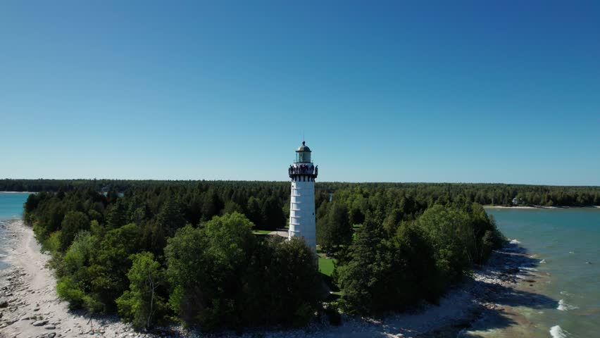 Slow orbiting drone shot of a light house in door county, Wisconsin