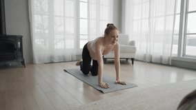 Pregnant woman doing pilates at home. Pregnant female doing yoga practice stretching with online lesson video trainer at home. Mother and child health relax and wellness healthy practices concept.