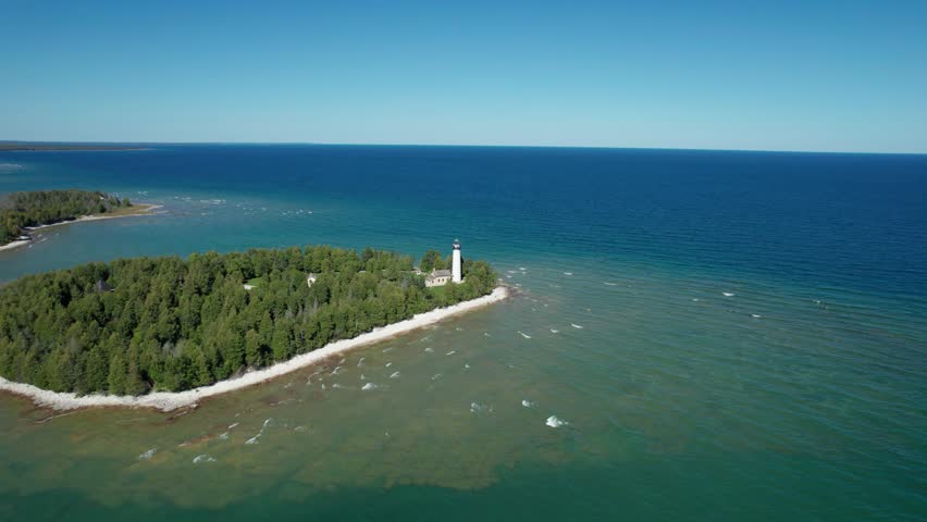 Drone aerial shot flying in towards the Old Baileys Harbor Bird Cage Lighthouse