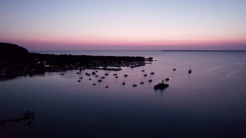 Drone shot flying over a marina in door county, Wisconsin at sunset