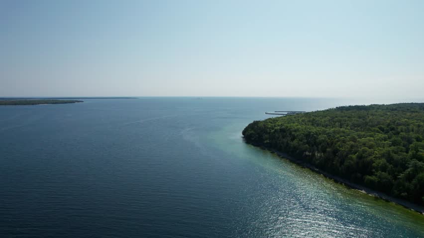 Drone aerial view of the shoreline of door county on a sunny day