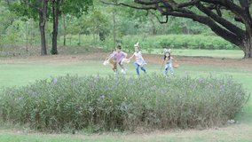 Children having fun in park, Kids holding baskets in their hands Then run in a race to hunt for eggs that fall into the grass. Put it in your basket, the concept of family fun at Easter, slow motion - Powered by Shutterstock - Get 15% off with code: PIKWIZARD15