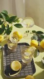 Healthy drinks set on the table decorated with lemons and flowers. Top view Vertical shot