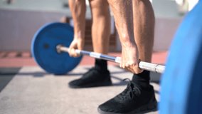 Fitness man doing Deadlift. Weightlifting fitness man bodybuilding or powerlifting at outdoors gym. Bodybuilder doing barbell weight workout deadlift with heavy bar.