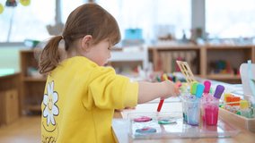 Little Girl Drawing Watercolours Using Palette Pipette Inside Art Studio in Slow Motion. Children Preschool Education - Powered by Shutterstock - Get 15% off with code: PIKWIZARD15