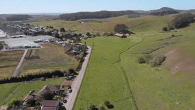 Slow drone fly over of agriculture goat farms and the pacific coast near Half Moon Bay california.