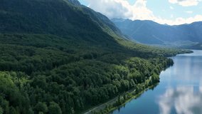 Aerial view of Bohinj lake in Julian Alps. Popular touristic destination in Slovenia. Bohinj Lake, Church of St John the Baptist. Triglav National Park, Julian Alps, Slovenia.  - Powered by Shutterstock - Get 15% off with code: PIKWIZARD15