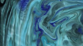 The blue and white flow in one direction. Mixing colors in slow motion. Abstract clip.