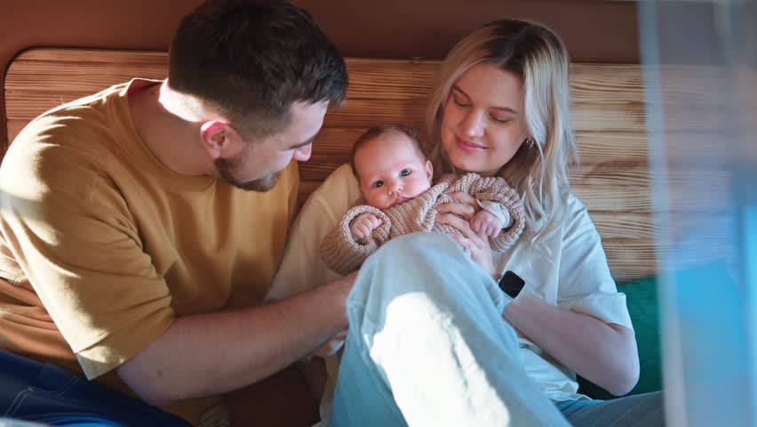 Family enjoys precious time in a camper van, encapsulating a moment of joyful parenthood.