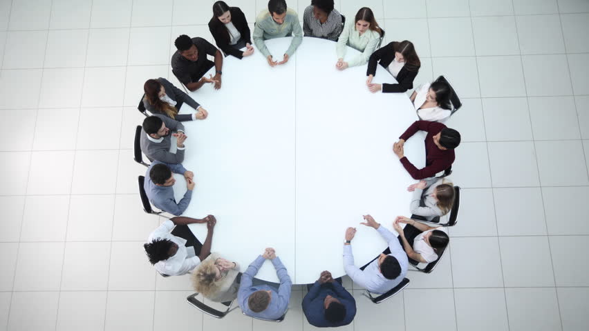 Businesspeople Sitting At Conference Round Table At The Meeting