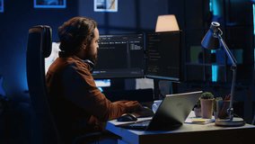 Software programmer taking break from coding, putting headphones on and stretching on desk chair during remote job shift. IT professional pausing tasks, listening music, loosening up, camera A - Powered by Shutterstock - Get 15% off with code: PIKWIZARD15