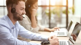 Guy from technical customer service support answering voice calls from clients in office - Powered by Shutterstock - Get 15% off with code: PIKWIZARD15