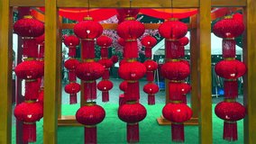 Chinese new year lantern decorations. Red lanterns with red glitter hanging from a wooden frame. Happy new year red lanterns. - Powered by Shutterstock - Get 15% off with code: PIKWIZARD15