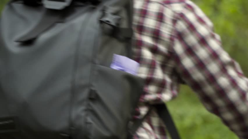 Volunteer bicyclist remove trash bags for garbage, clean up forest during bicycle ride. Save environment. Recycle waste litter rubbish garbage trash junk clean training. Picking up trash while cycling