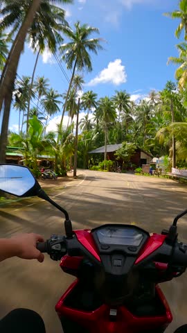 Riding a scooter on a tropical island in Thailand. POV