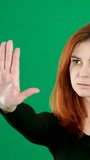 put your hands forward in protest no stop woman sticks out puts her palms to the side looks with a serious look on a green background chromakey