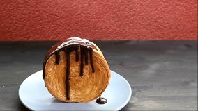 Footage of a Mouthwatering Supreme Croissant or New York Roll with Flowing Chocolate Sauce - Powered by Shutterstock - Get 15% off with code: PIKWIZARD15
