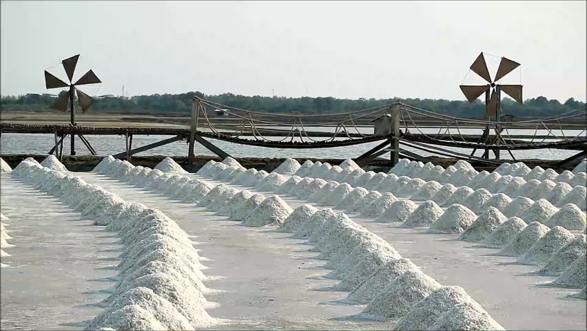 Footage of Salt Farm with Hand Harvested Raw Salt Piles in Petchaburi Province, Thailand