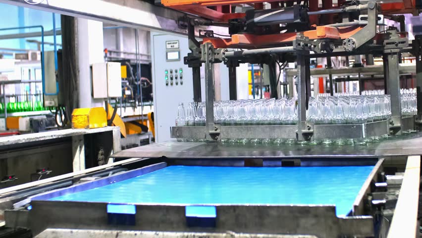 Glass factory, production of glass containers. Packaging of food containers. Robotics in industry. Modern technologies, robotic machines produce products. Technological work at the plant. Royalty-Free Stock Footage #3458630861