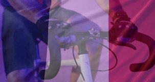 Animation of confetti and flag of france over caucasian man cycling. Sport, patriotism and celebration concept digitally generated video.