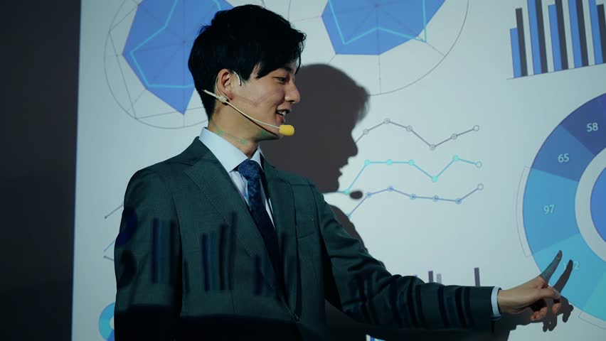 Asian businessman giving a presentation using a projector and digital documents concept. Royalty-Free Stock Footage #3458650583
