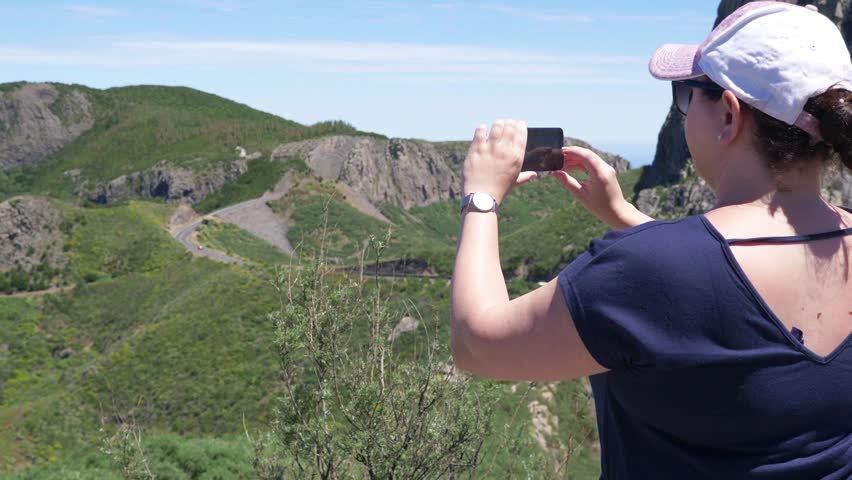 Woman takes picture of Roque de Agando in Spain in 4k slow motion 60fps