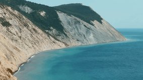 Panoramic view of the sea surface from the coast. Black Sea, Anapa, Krasnodar Territory, Russia. Sunset view of Bald Mountain near the village of Supseh. The beach has 800 steps. 4K Video