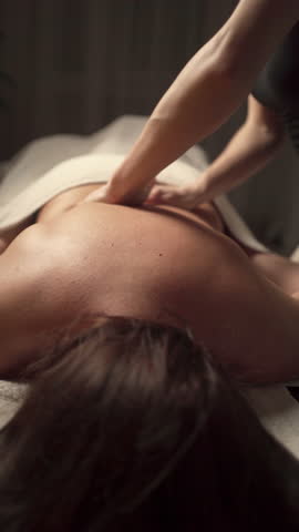 close-up of masseur hands doing back massage for woman in spa center. Copy space Royalty-Free Stock Footage #3458674811