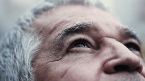 Contemplative gaze of senior man close-up eyes looking up with HOPE and FAITH. wrinkled aged Spiritual older person looking UPWARDS - Powered by Shutterstock - Get 15% off with code: PIKWIZARD15