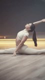 Wellness, sportswoman is doing yoga in a room, flexible woman performs a stretching with yoga elements, vertical video.