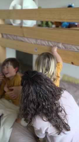 Happy young family having fun in children bedroom