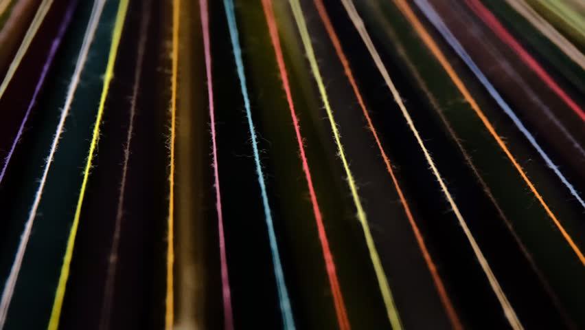 Converging Multi-colored Sewing Thread on a rotating table, on dark background Royalty-Free Stock Footage #3458811995