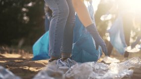 volunteers collect plastic in forest park. large team a group of people family collects plastic bottles in lifestyle cellophane garbage bags. volunteering environmental pollution business concept - Powered by Shutterstock - Get 15% off with code: PIKWIZARD15