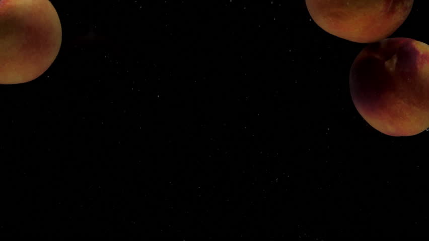 Slow motion three peaches falling into transparent water on black background. Fresh fruits splashing in aquarium. Healthy food, air bubbles - Powered by Shutterstock - Get 15% off with code: PIKWIZARD15