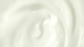 Slow motion macro shot of white yogurt, top view. Sour cream or fresh greek yogurt. rotation.